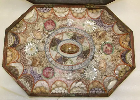 An octagonal sailor’s valentine with an intricate arrangement of shells